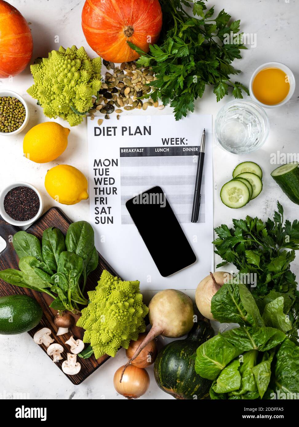 Smartphone and Diet plan on the sheet Set of healthy food on the table. Top view Stock Photo