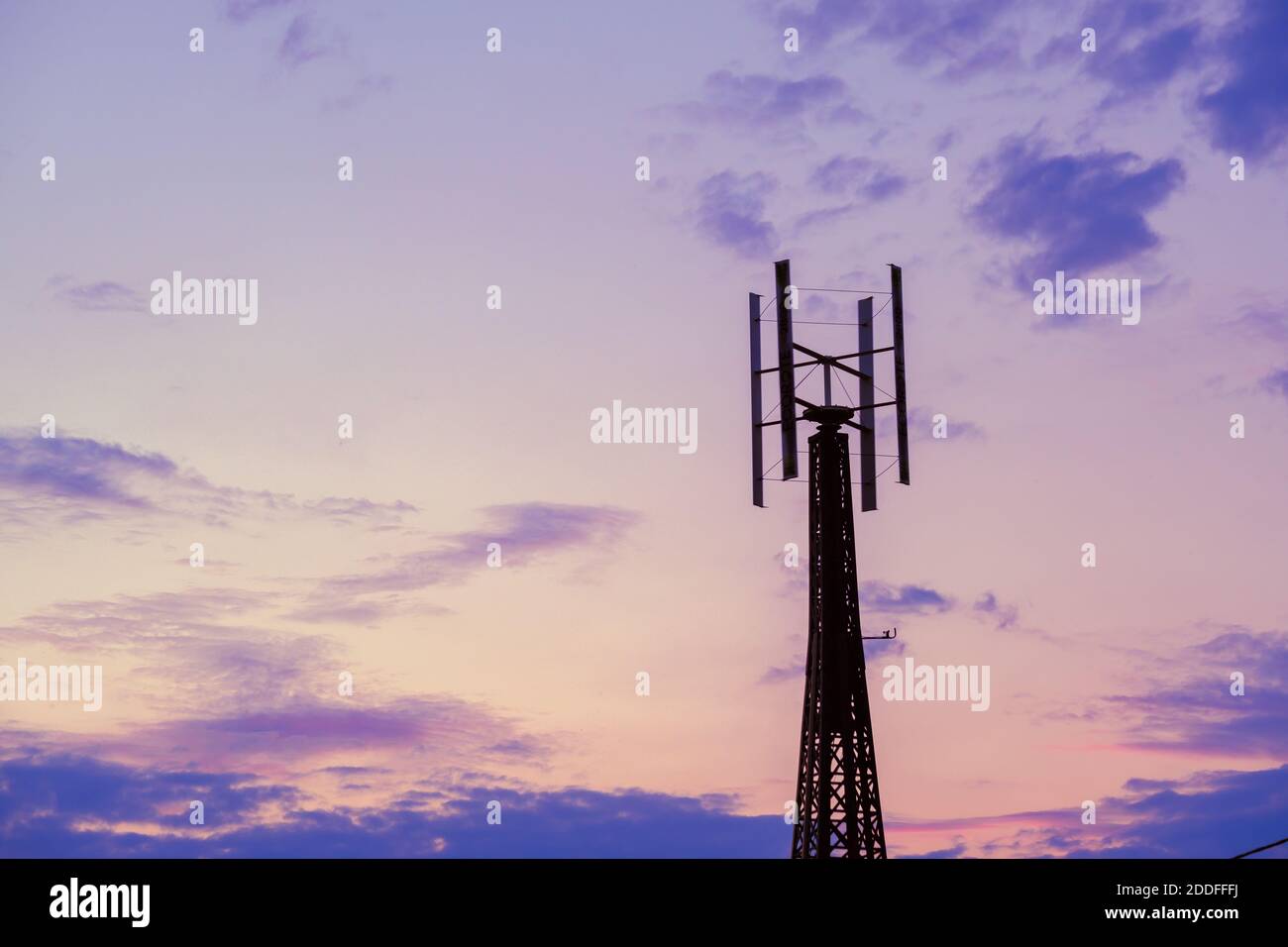 Telecommunication tower against sunset sky in evening Stock Photo