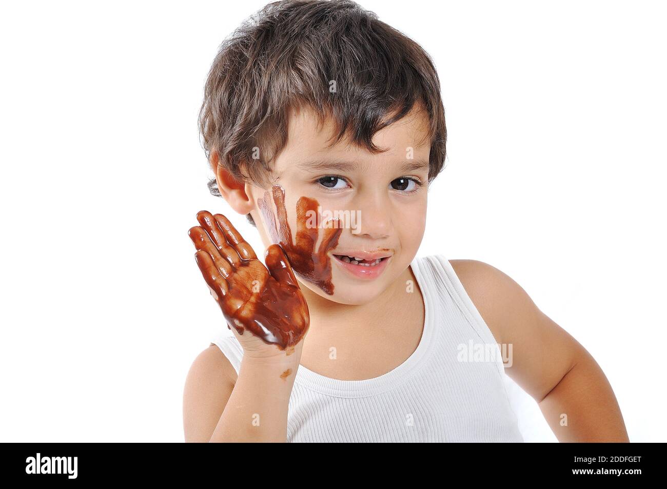 Little cute kid with chocolate on face and hands Stock Photo Alamy