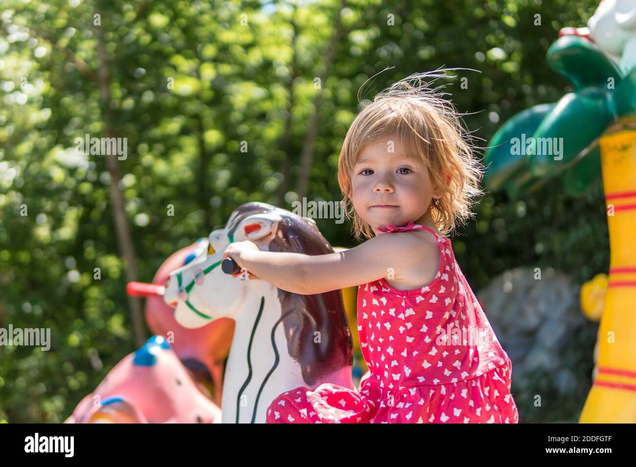 Happy little girl is playing in playground Stock Photo - Alamy