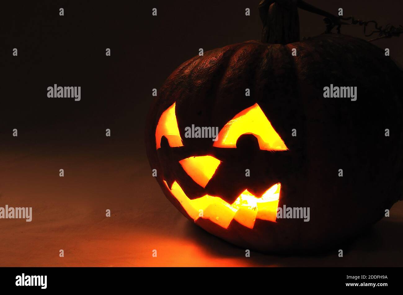 The carved face of pumpkin glowing on Halloween Stock Photo - Alamy