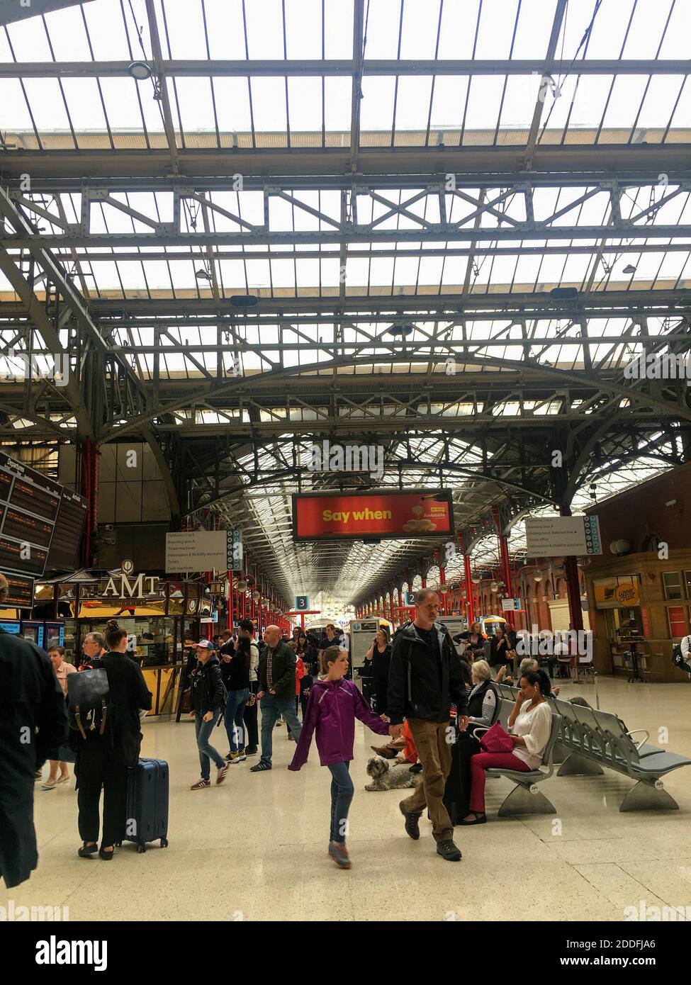 People rushing at a rail station Stock Photo