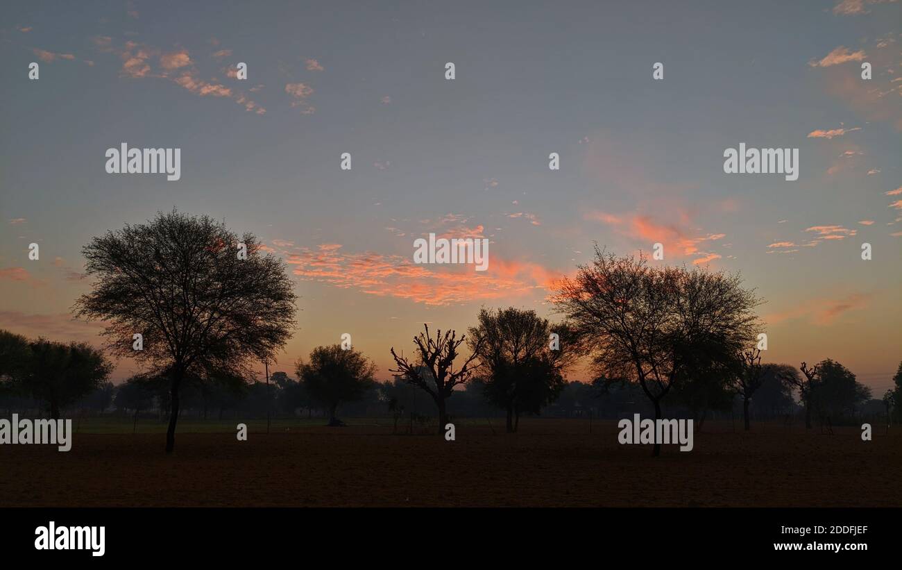 Dramatic dense clouds hovering in sky in the evening time. Darkness appearing during the sunset. Stock Photo