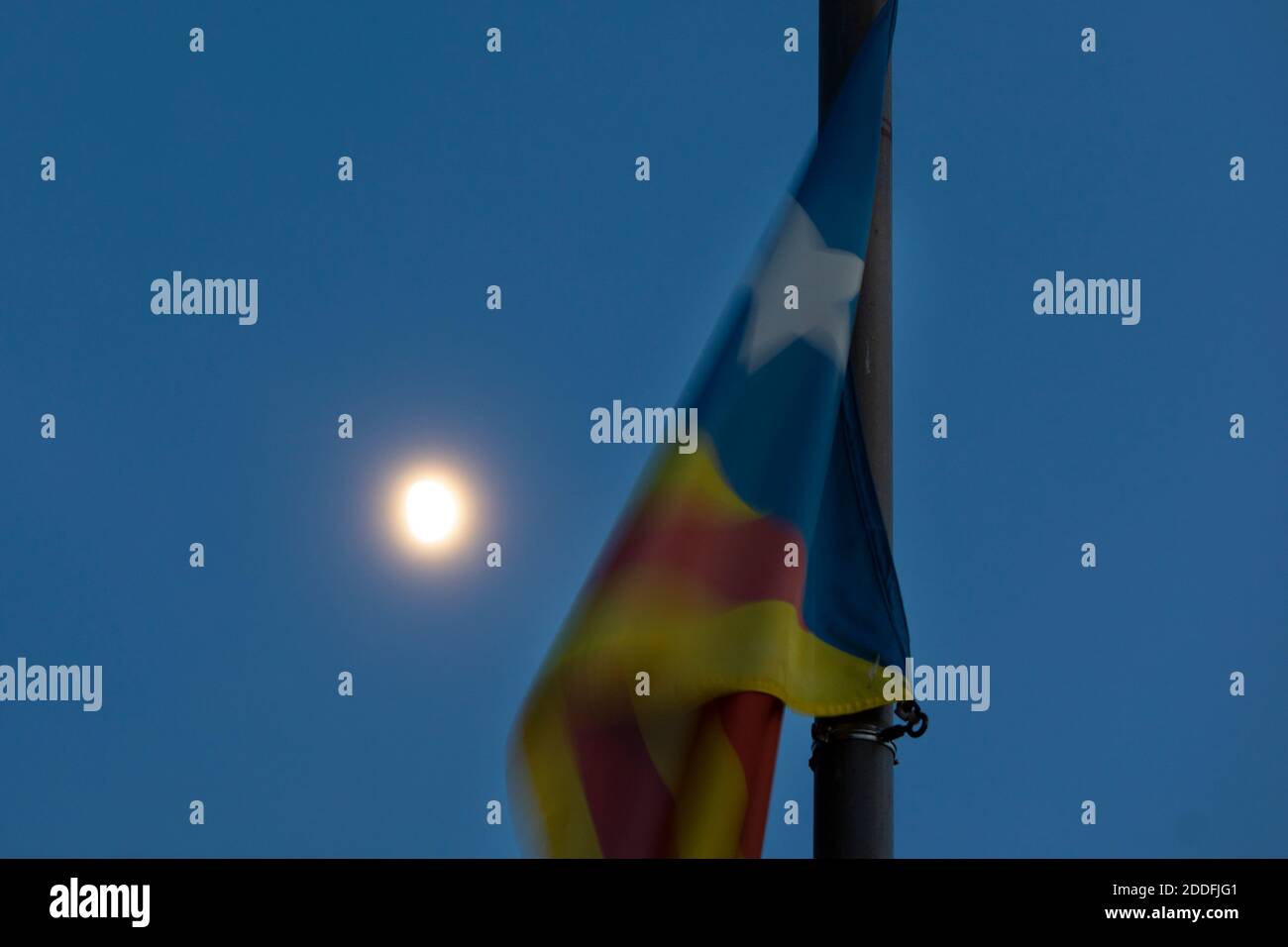 Estelada (flag) with moon rising in the background Stock Photo