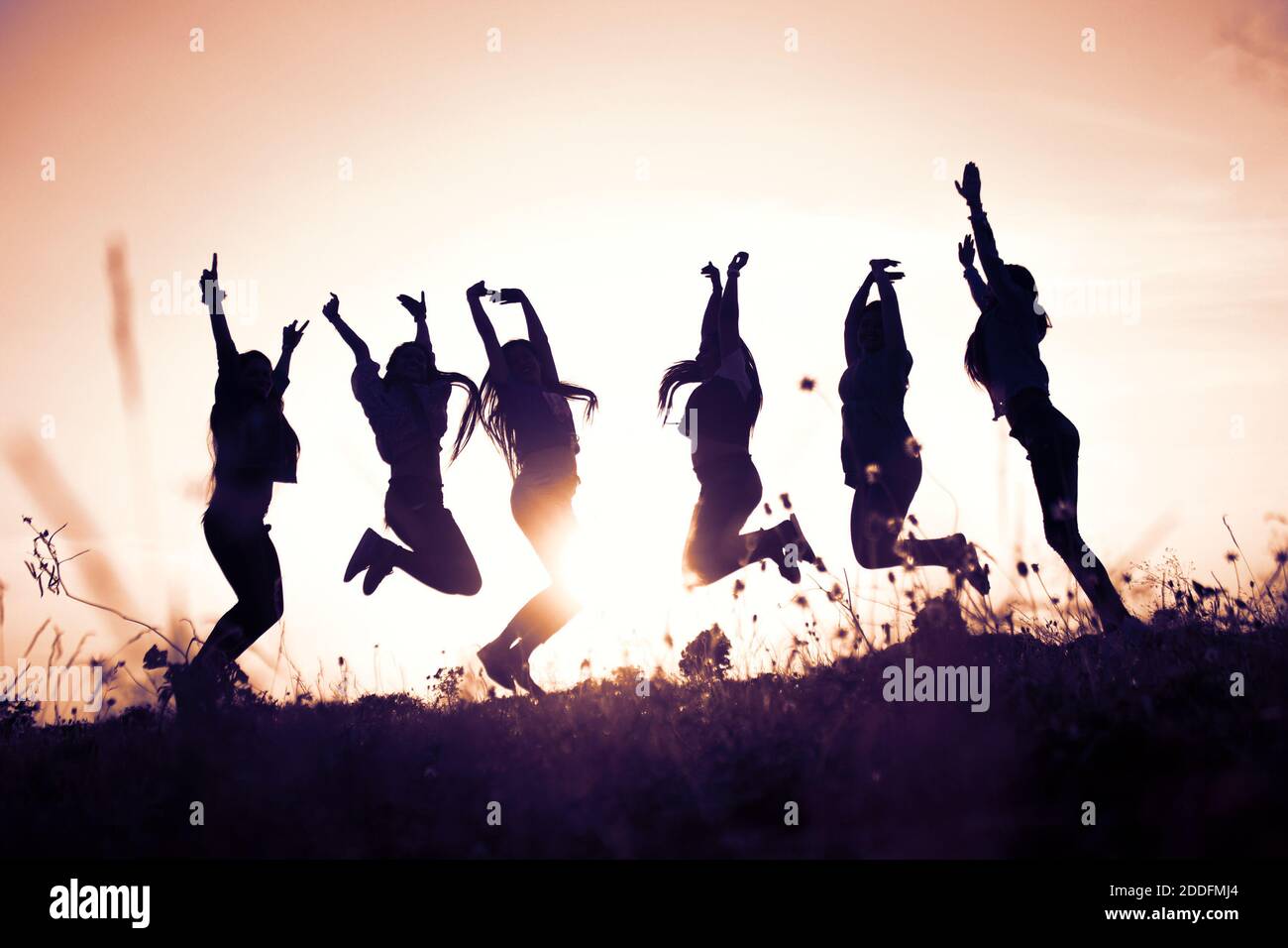 Silhouette of youngster celebration against the sky . Stock Photo