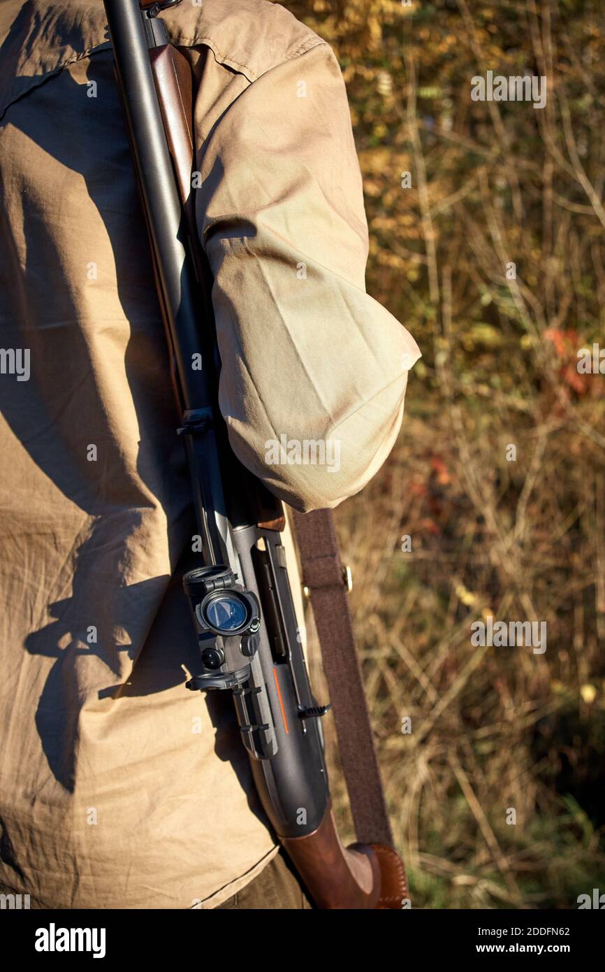 Hunter hunting in the forest with a hunting rifle. A man with a gun ...