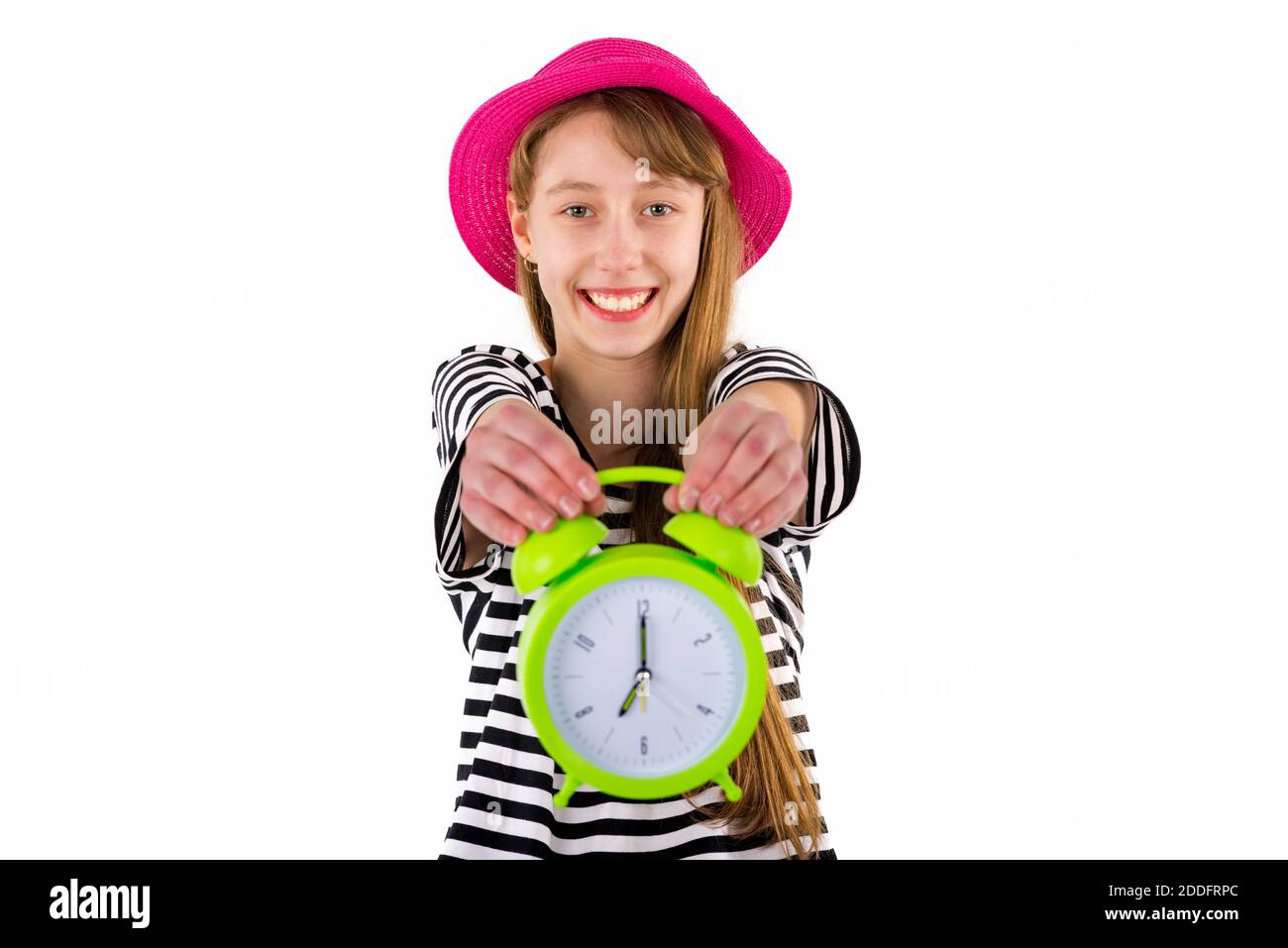 Teen Girl holding alarm Clock, isolated on white background. Portrait of caucasian teenager