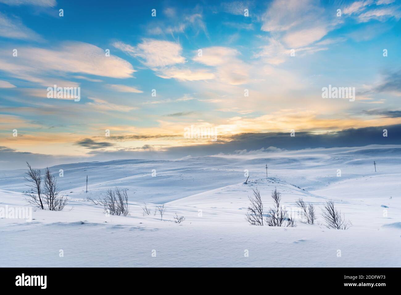 Power line traverses a snow covered remote region in the Arctic Stock Photo