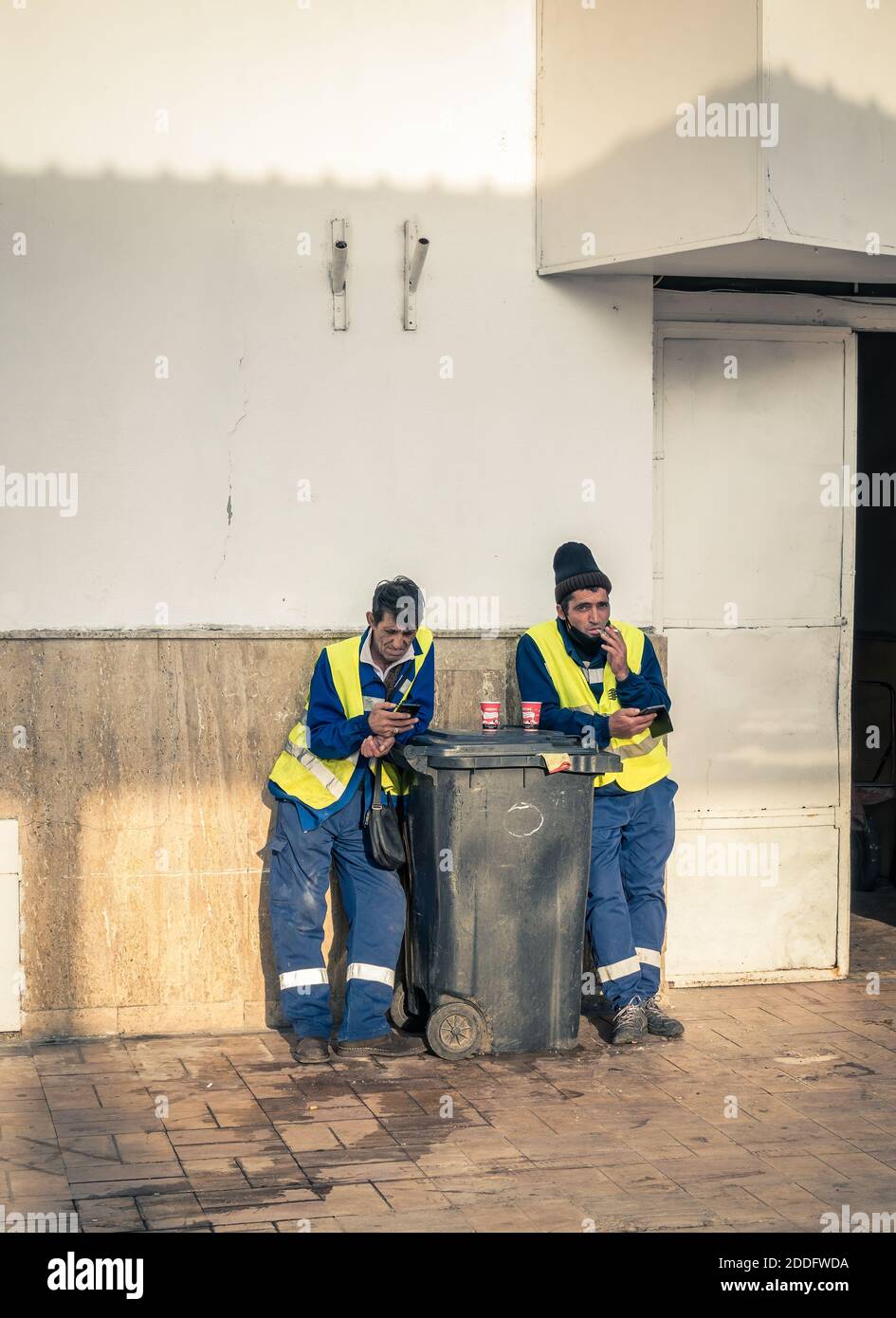 Bucharest/Romania - 11.16.2020: Workers or garbage man taking a cigarette and coffee break break Stock Photo