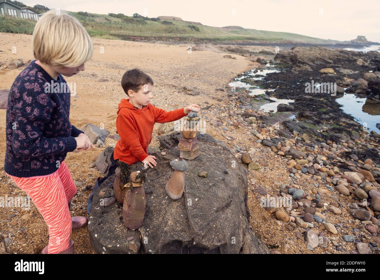 This is such a great pastime at the beach, get your kids to collect small rocks and seaweed and other things you find on the beach and build things. Stock Photo