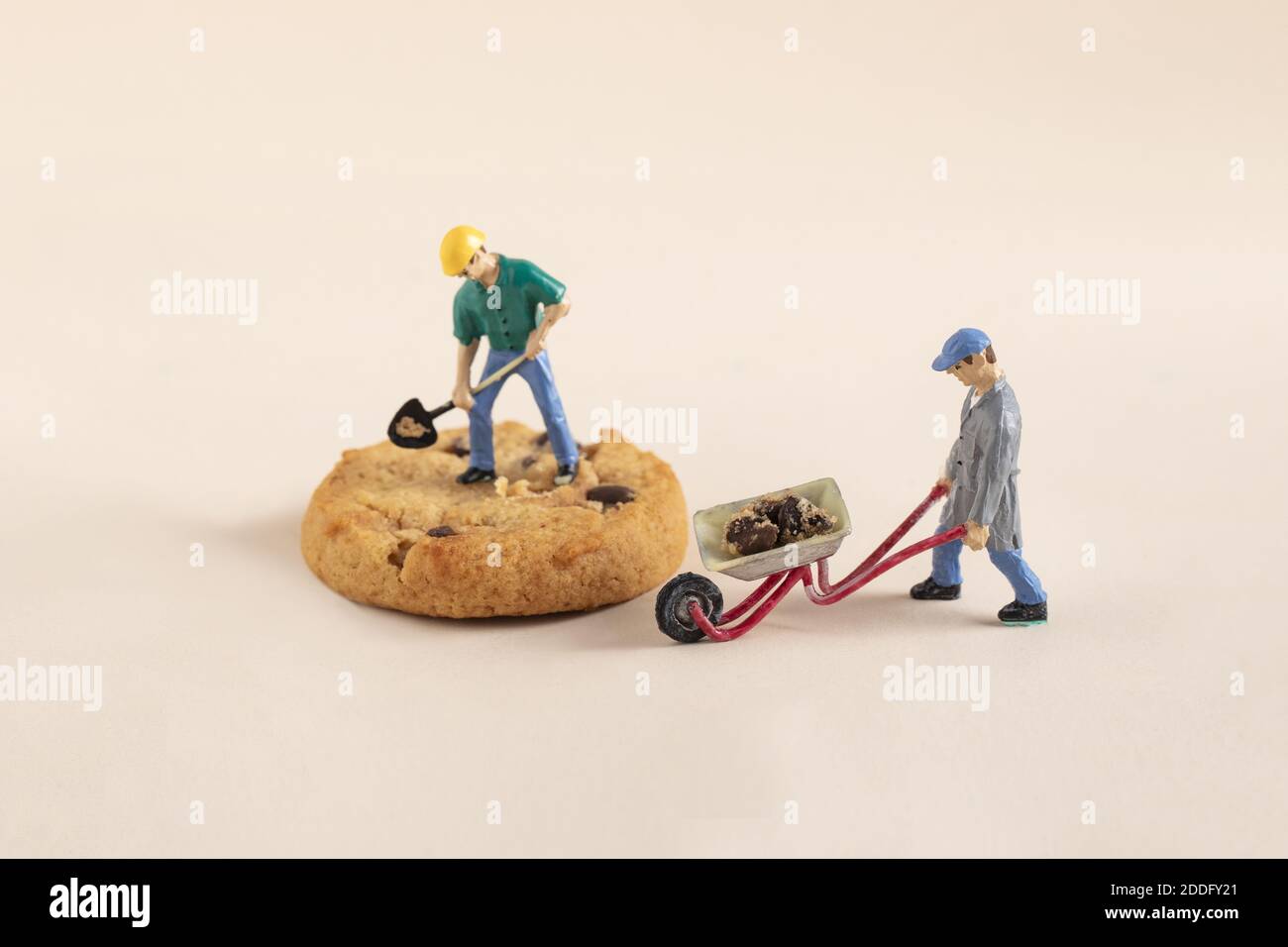 A closeup shot of mini construction worker figurines working on a
