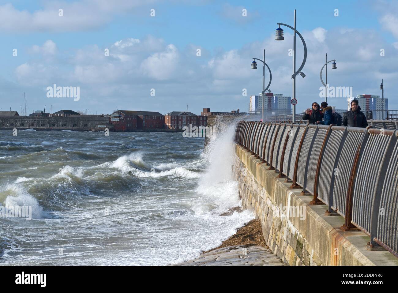 View along the seafront at Old Portsmouth, Hants, during a rough winter storm, with waves breaking against the seawall in front of the Kings Bastion. Stock Photo