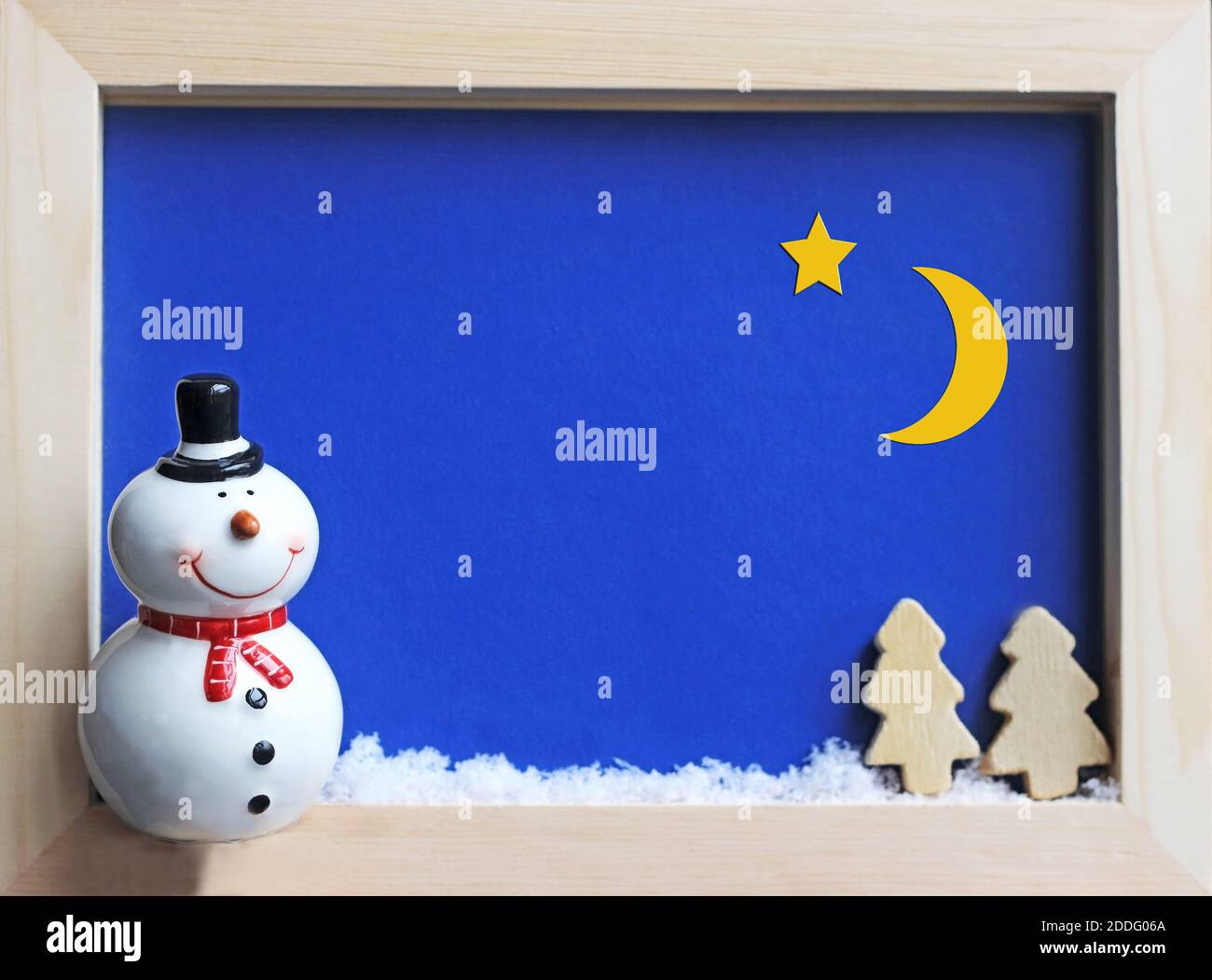 framed winter scene with a snowman at night and a starry sky, background or greeting card with copy space Stock Photo