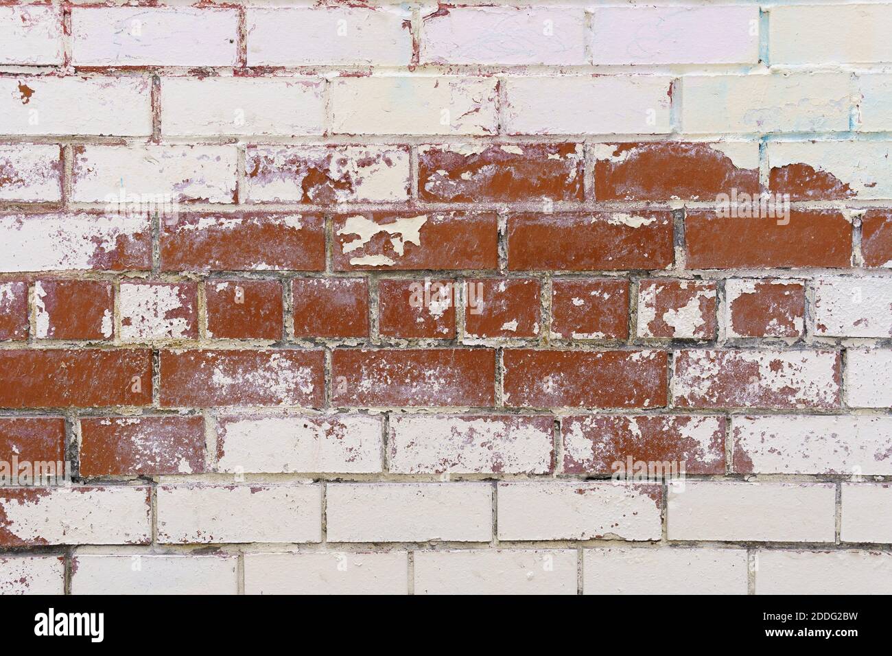 Brick wall textures. Painted problem wall surfaces. Red Stone Background. Worn facade of the building with damaged plaster. Stock Photo