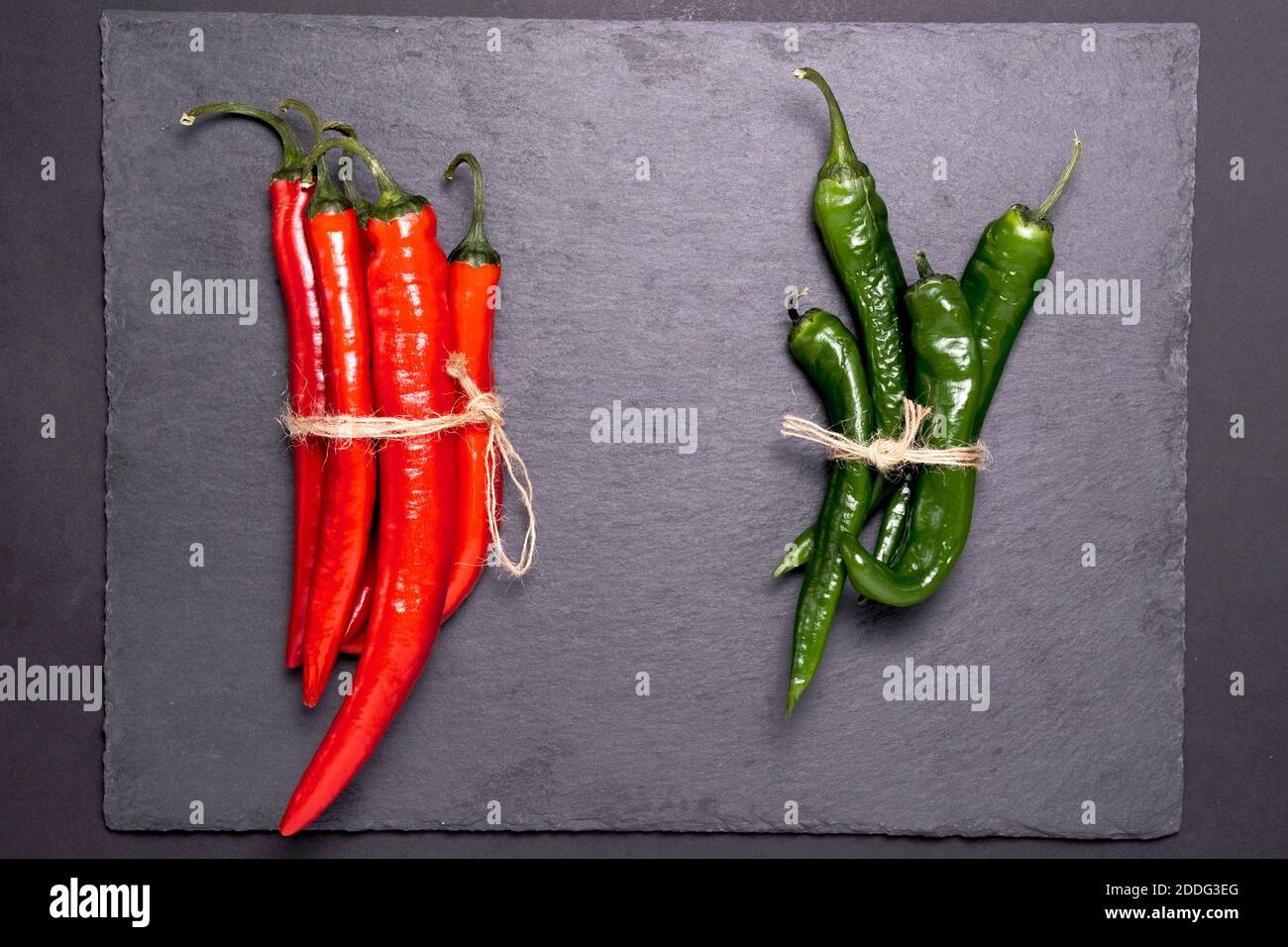 Red and green hot chili peppers with black background. flat lay Stock ...