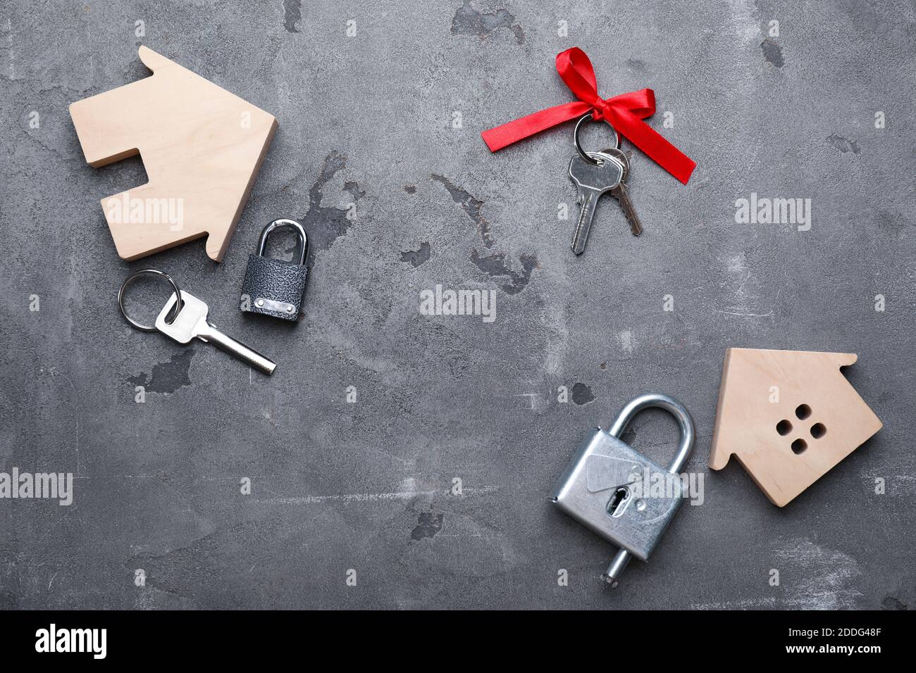 Keys from house and padlocks on dark background Stock Photo