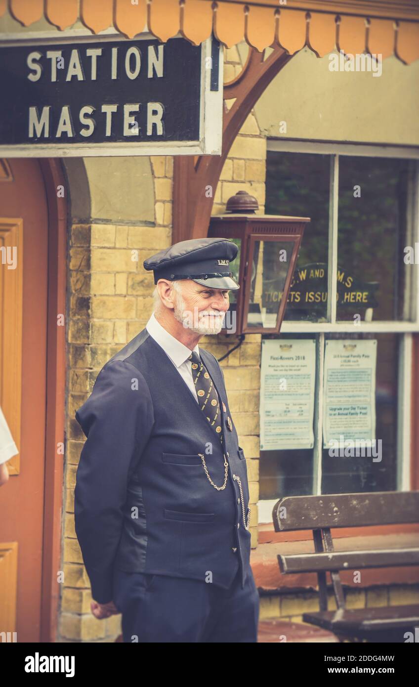 station master on duty at a heritage steam railway building Stock Photo