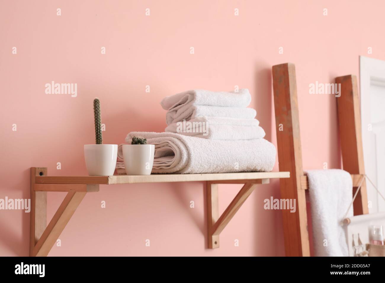 Modern interior of stylish bathroom with towels on shelf Stock Photo