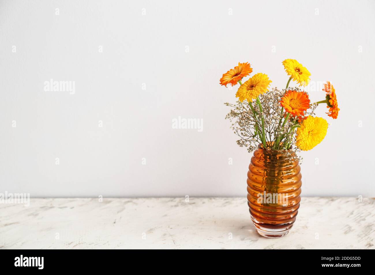 Beautiful glass vase with flowers on white background Stock Photo - Alamy