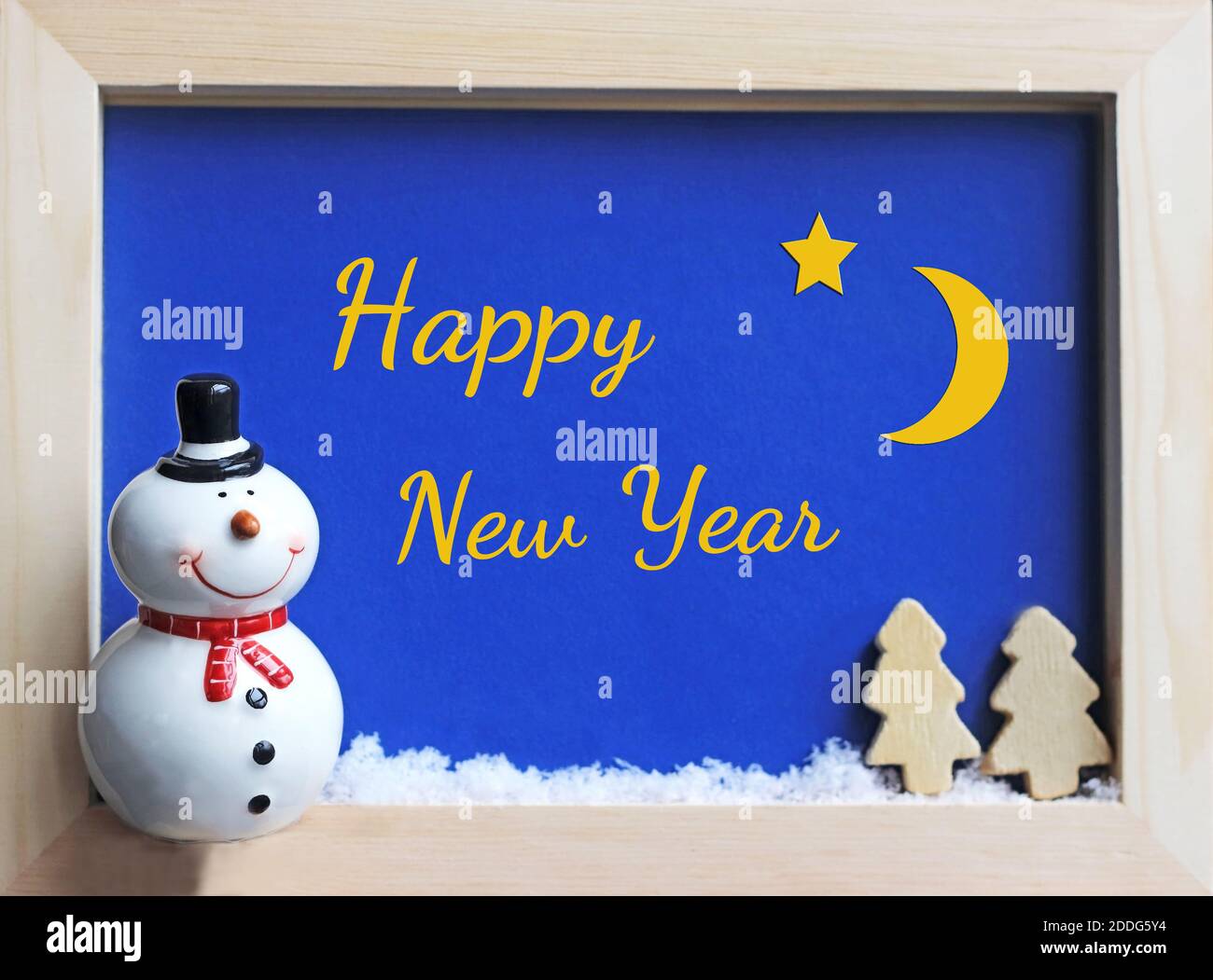 framed winter scene with a snowman at night and a starry sky, New Year greeting card Stock Photo