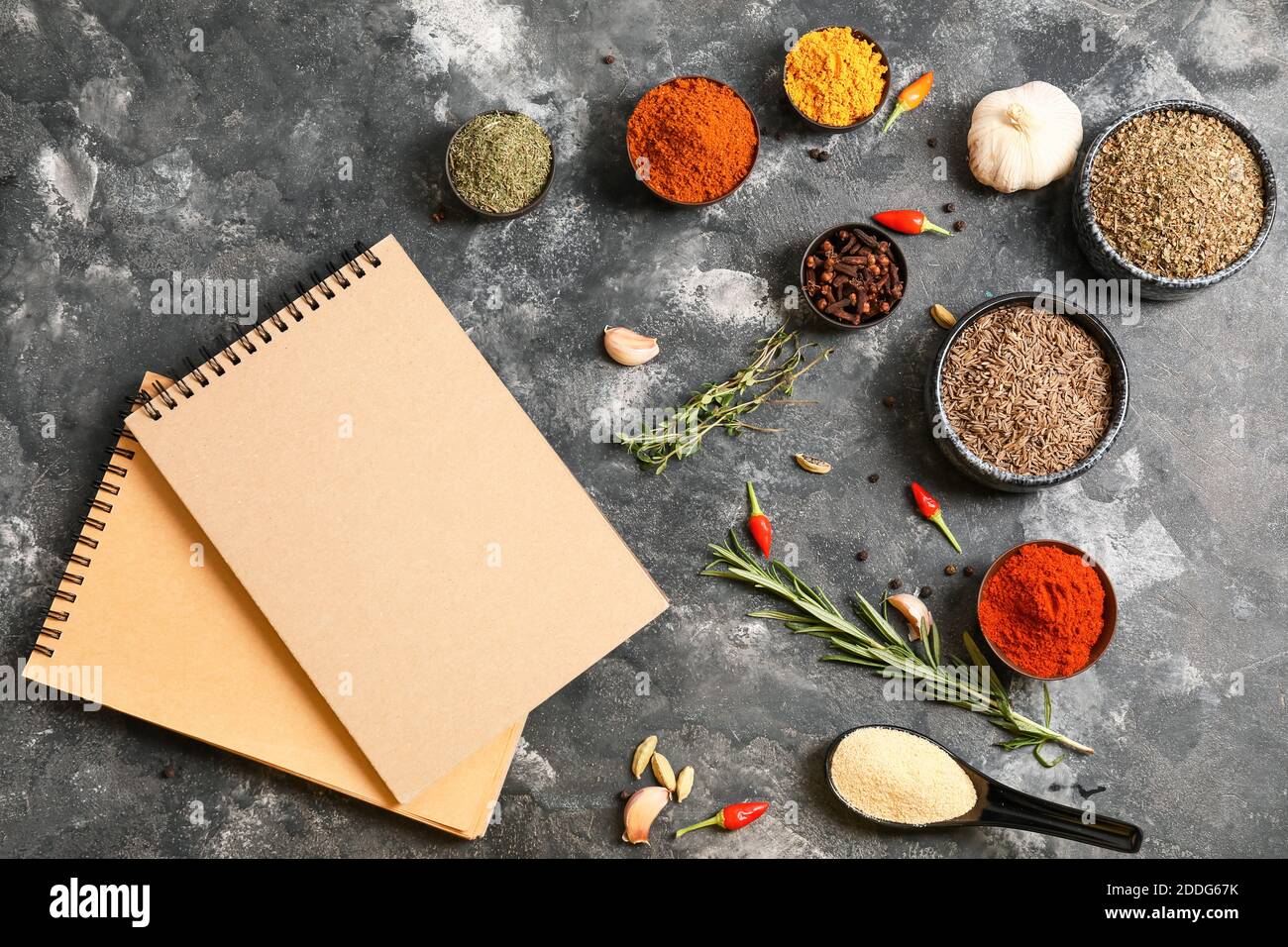 Notebooks for recipes and spices on grey background Stock Photo