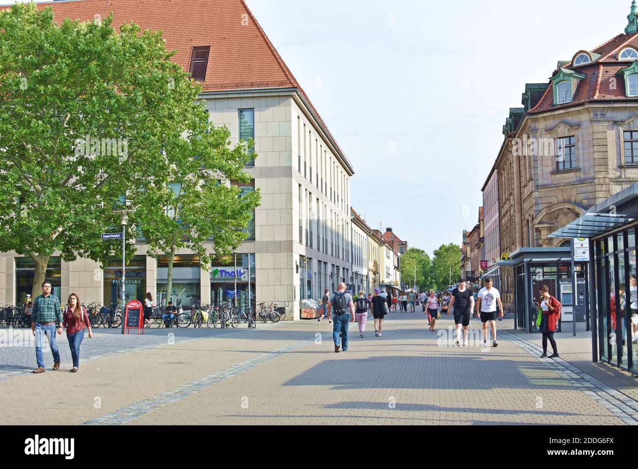 People walking along the street in the city center. Stock Photo