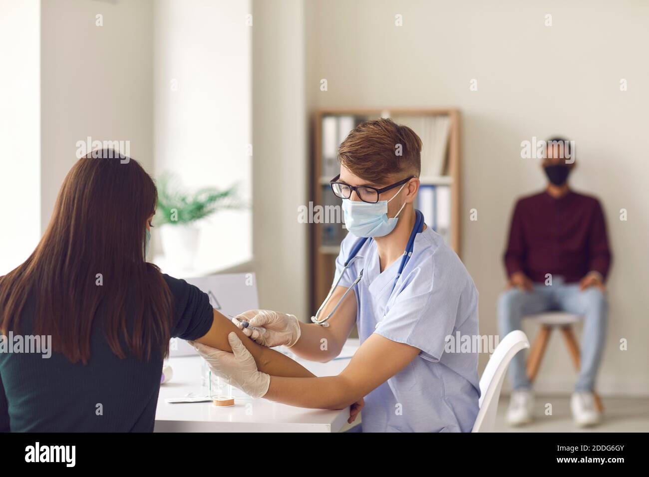 Doctor giving injection shot in hi-res stock photography and images - Alamy