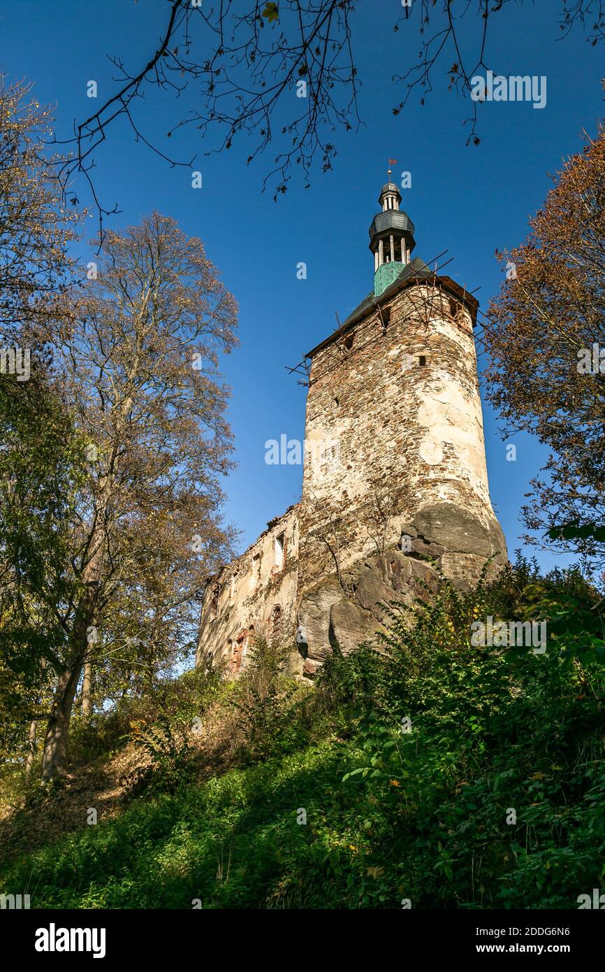 Hartenberg, Czech Republic - October 14 2018: View of a tower as a part of the ruined gothic castle in reconstruction standing on a rock with trees. Stock Photo