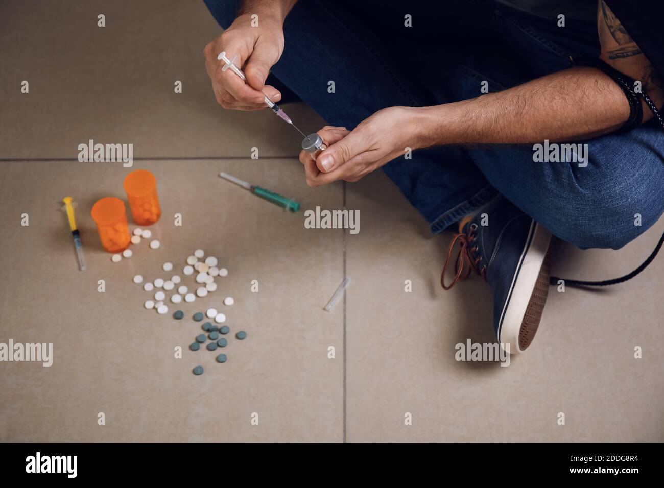 Male junkie making injection indoors. Concept of addiction Stock Photo ...