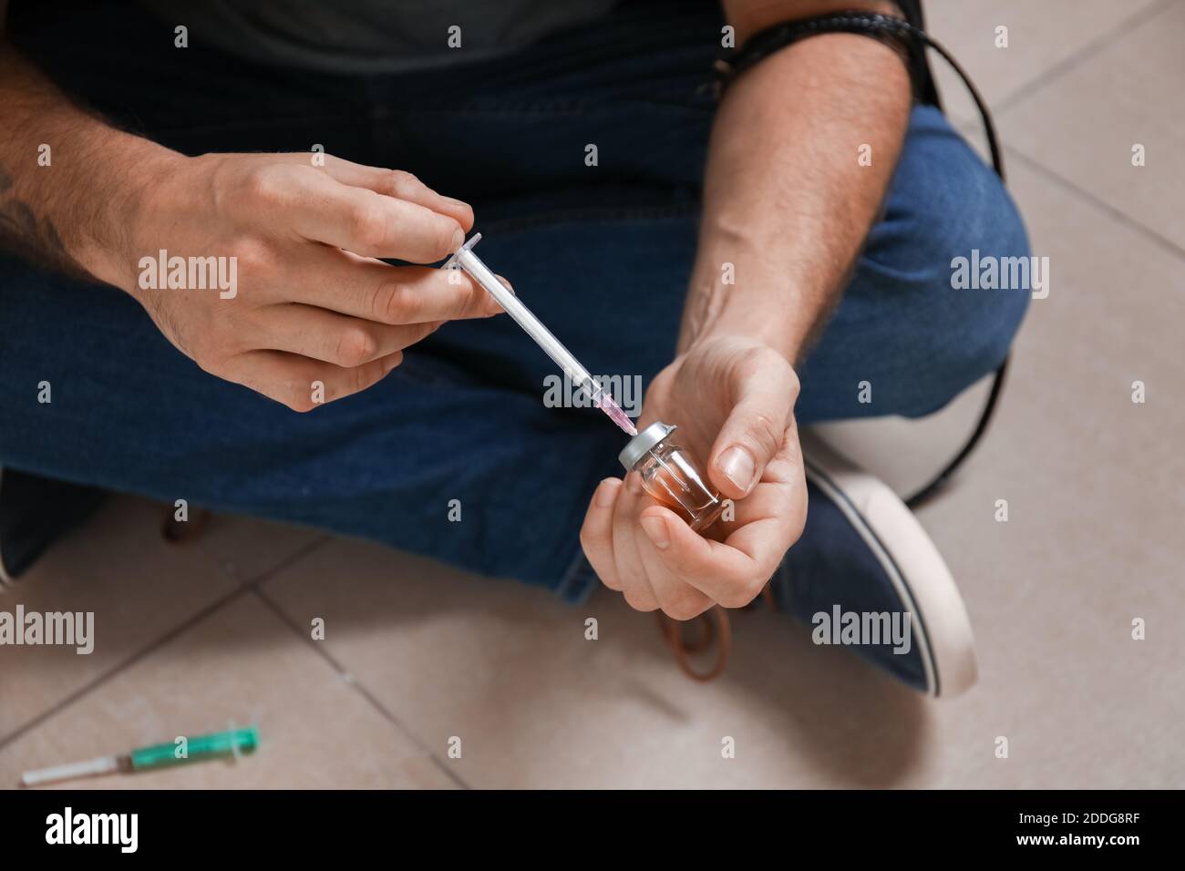 Male junkie making injection indoors. Concept of addiction Stock Photo ...