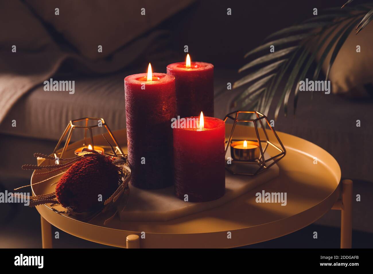 Beautiful aroma candles on table in dark room Stock Photo - Alamy