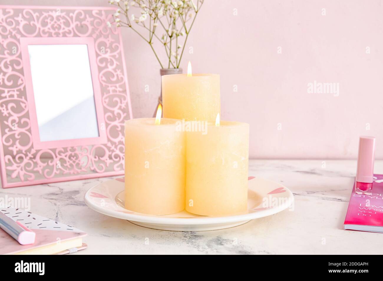 Beautiful aroma candles on table in room Stock Photo - Alamy