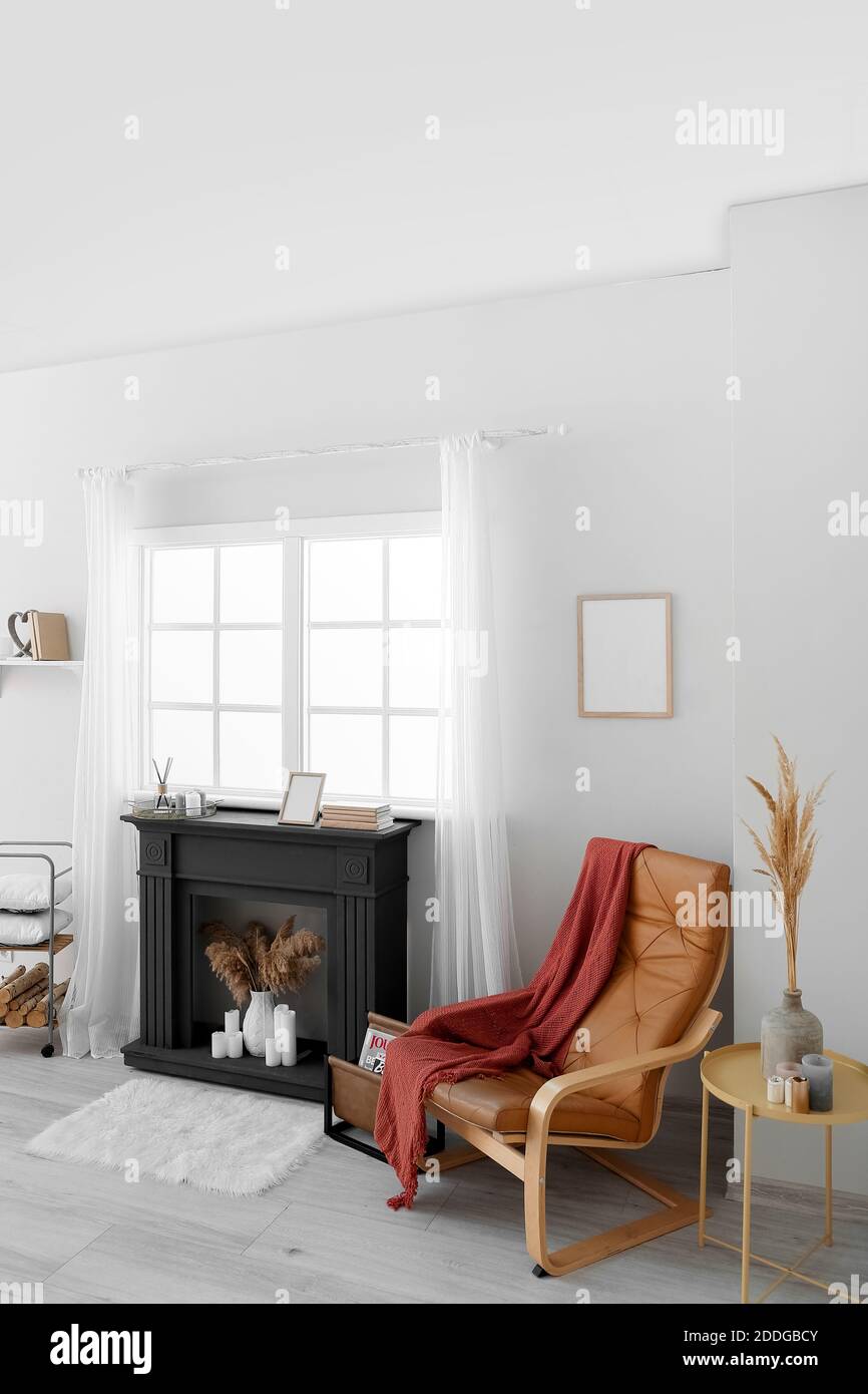 Interior of modern living room with fireplace and armchair Stock Photo ...