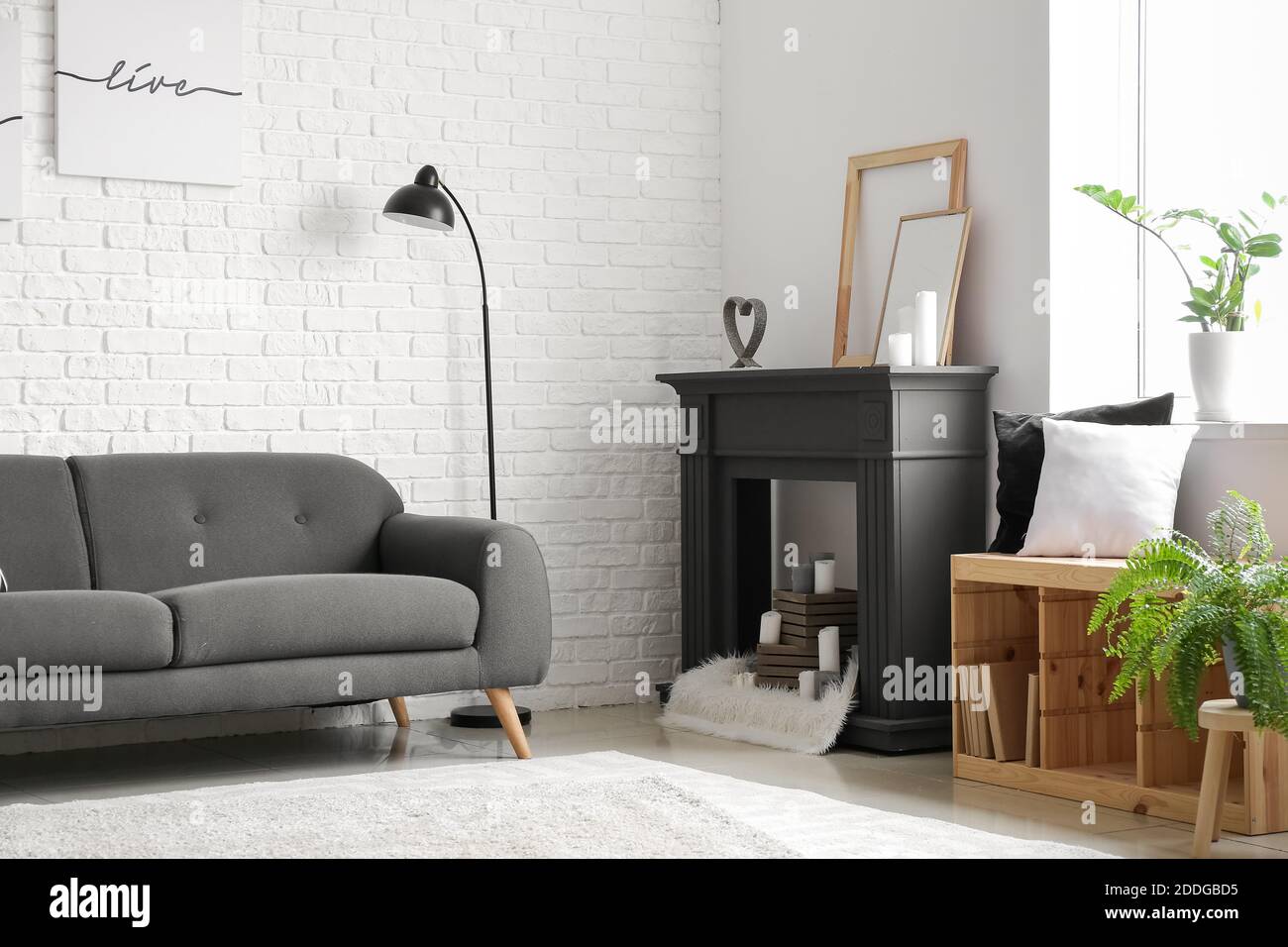 Interior of modern living room with fireplace and sofa Stock Photo - Alamy