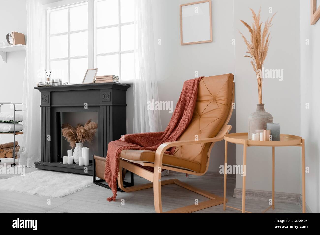 Interior of modern living room with fireplace and armchair Stock Photo ...