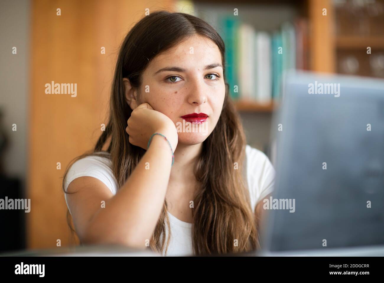 Young woman working at computer in library Stock Photo