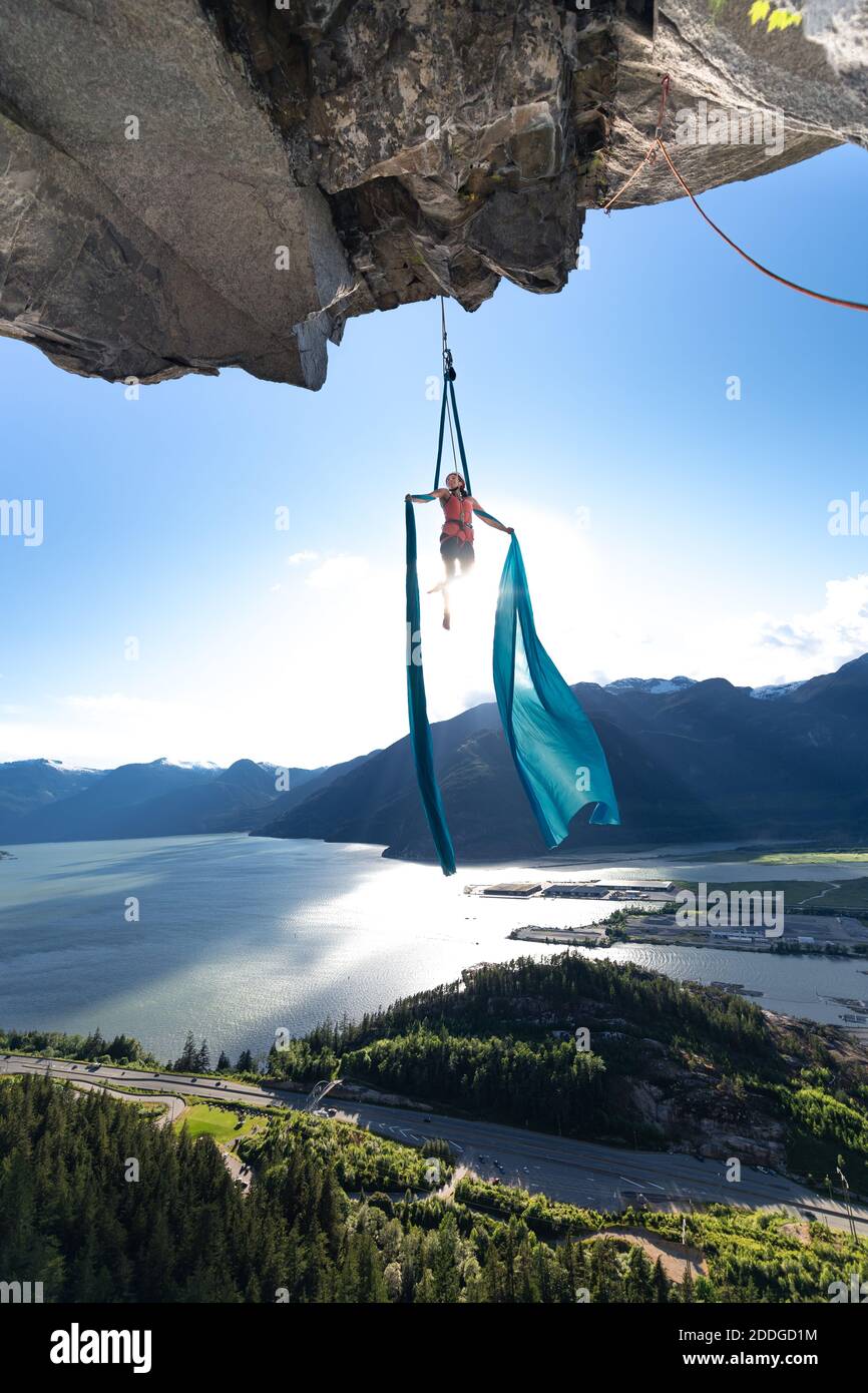 Woman on aerial silks on the Stawamus Chief in Squamish, British Columbia, Canada Stock Photo