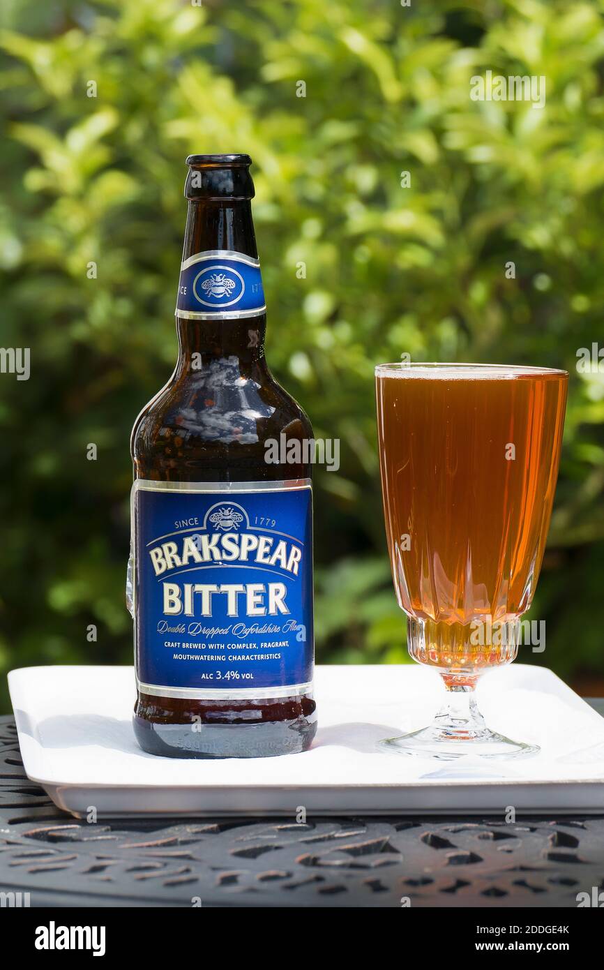 A bottle and glass of Brakspear Bitter ale poured ready to drink outdoors in UK Stock Photo