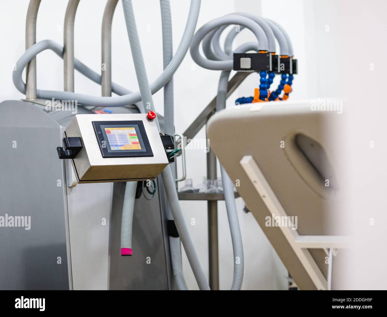 Modern vacuum machine with colorful screen located near bench inside physiotherapy office in hospital Stock Photo