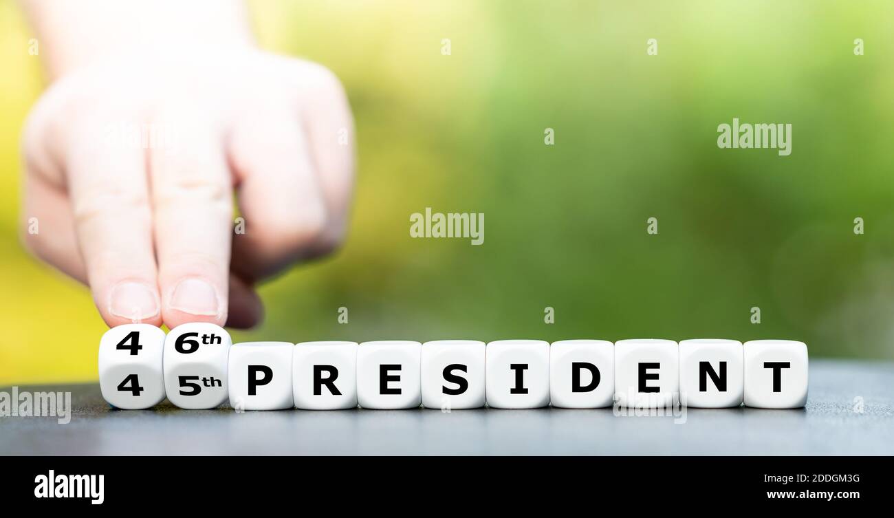 Hand turns dice and changes the expression '45th president' to '46th president'. Stock Photo