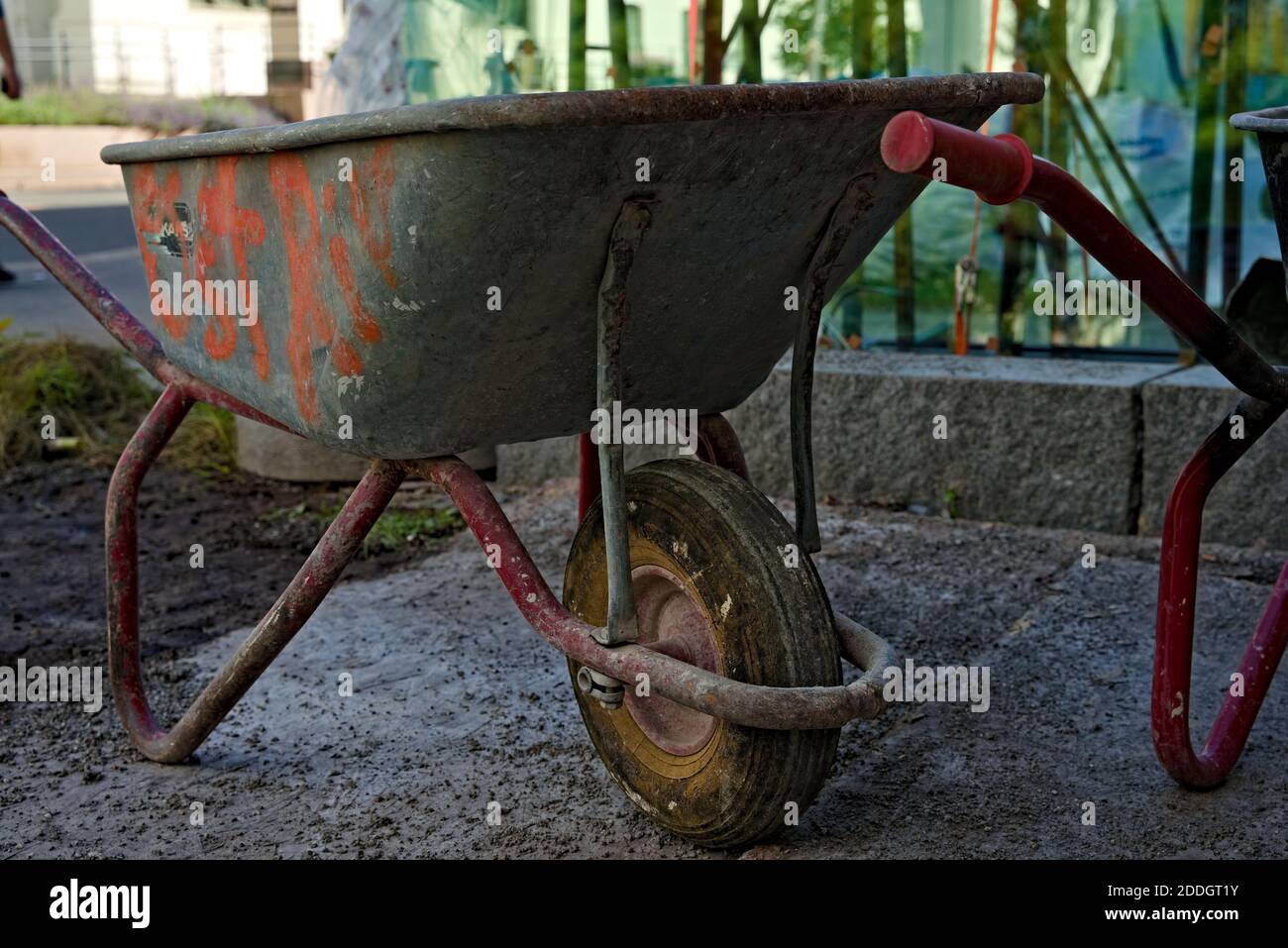 Dirty and used wheelbarrow at a urban construction site. . High quality