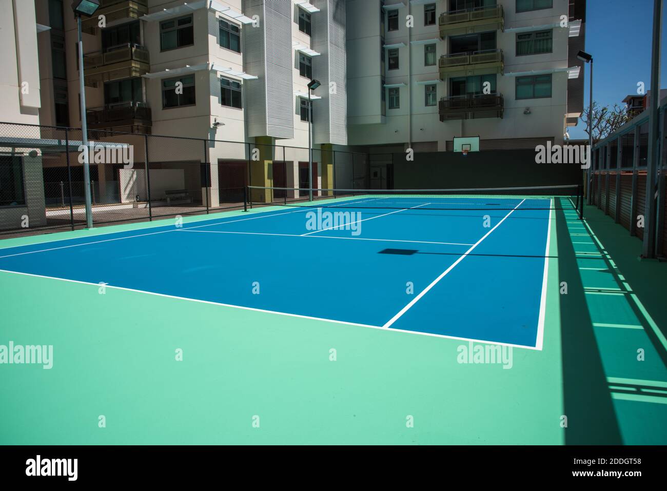 Darwin, NT, Australia-August 20,2018: Tennis court at the Esplanade Apartments with basketball net in Darwin, Australia Stock Photo