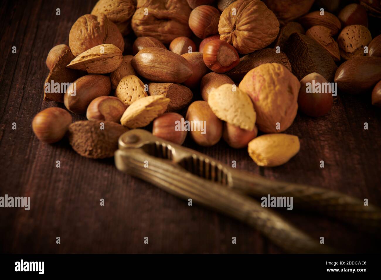 Mixed nuts in their shells with vintage nut crackers , England, Uk, Gb