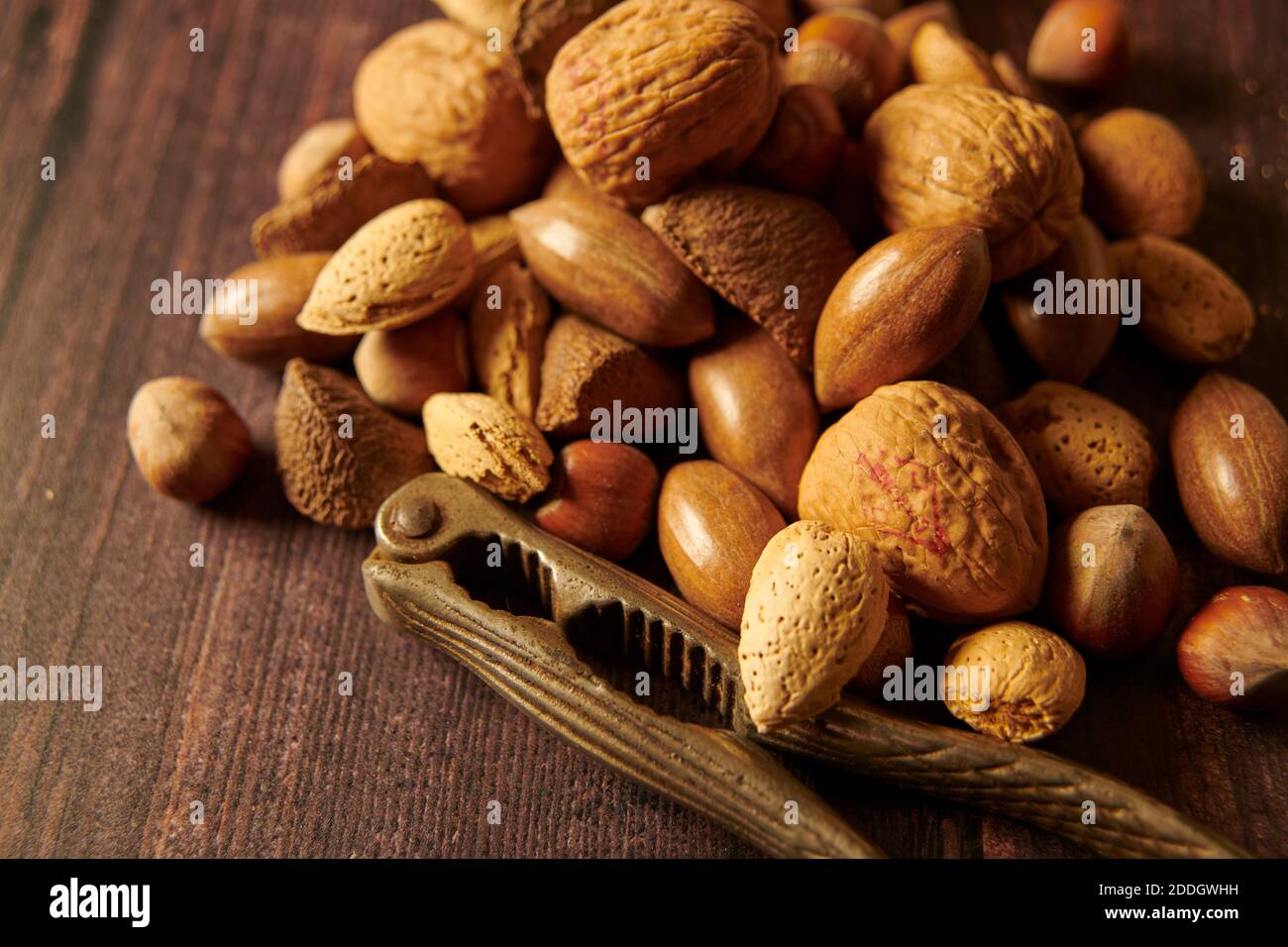 Mixed nuts in their shells with vintage nut crackers , England, Uk, Gb
