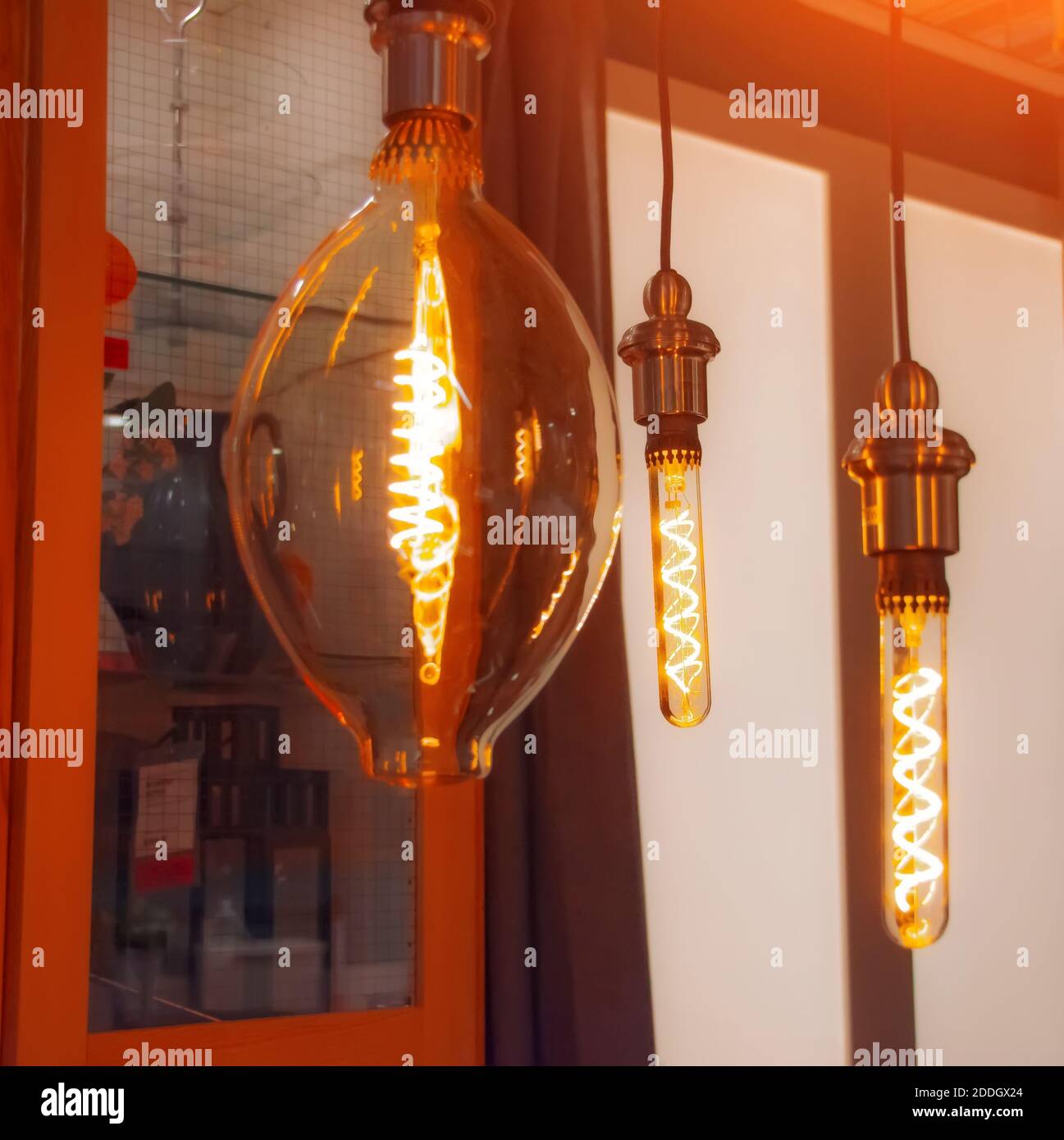 Vintage lamps with a luminous LED spiral in the form of bulbs, ovals and drops in a retro interior Stock Photo