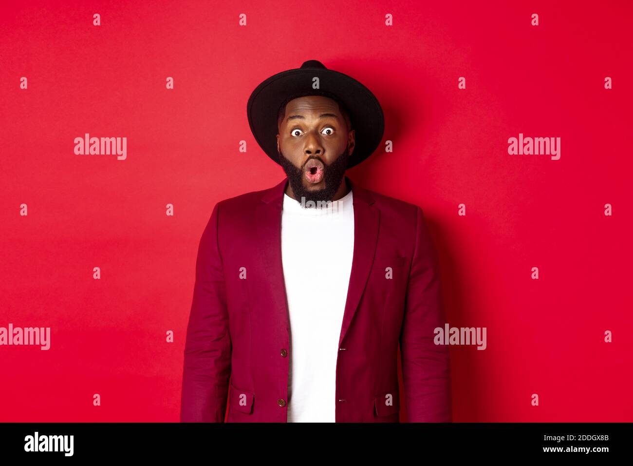 Fashion and party concept. Impressed Black man in classy outfit 