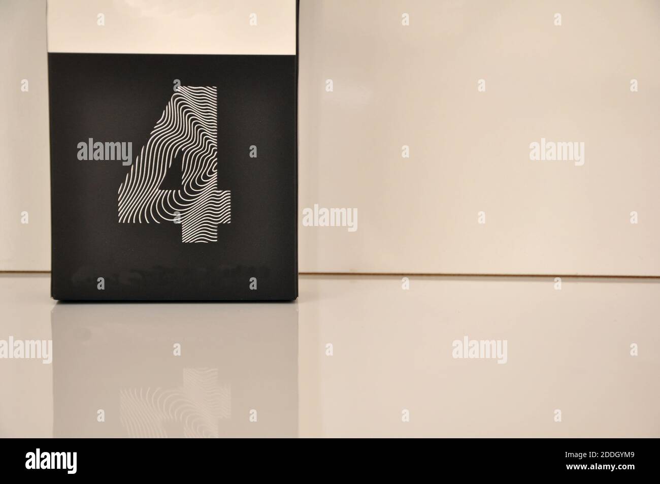 Cardboard in white color, with black background and number four in white, with white background and copy space, Brazil, South America Stock Photo