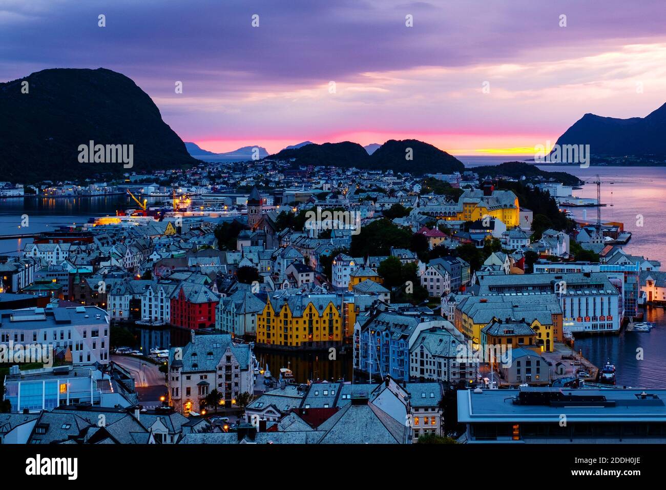 Alesund, Norway. Aerial view of Alesund, Norway at sunset. Colorful night sky over famous touristic destination with port and mountains Stock Photo