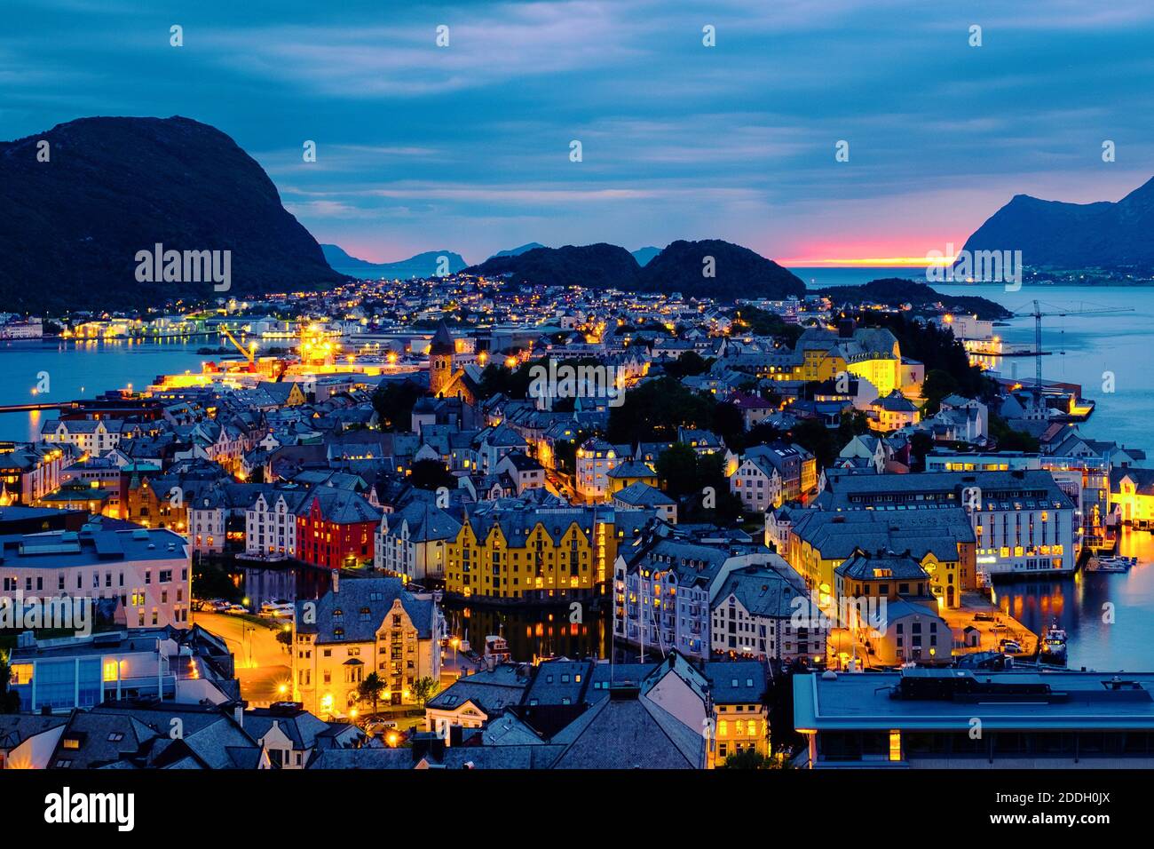 Alesund, Norway. Aerial view of Alesund, Norway at sunset. Colorful night sky over famous touristic destination with port and mountains Stock Photo