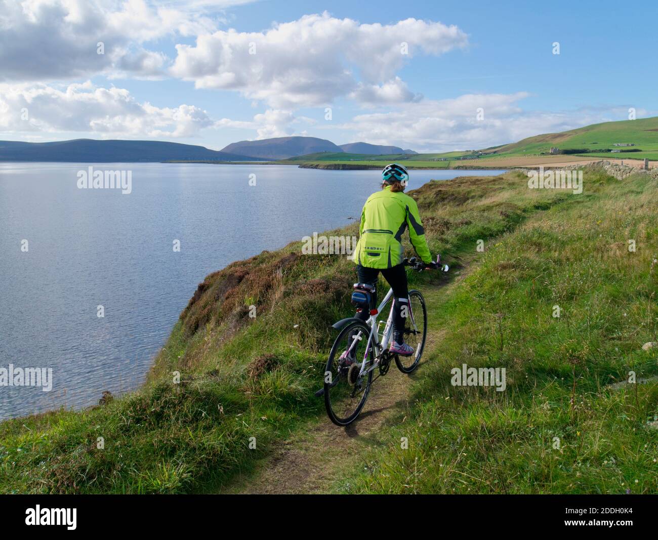 Cyclist on St Magnus Way coastal trail, Orkney Isles Stock Photo